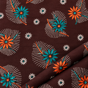 Close-up of brown cotton nighty fabric with orange, teal and white floral print